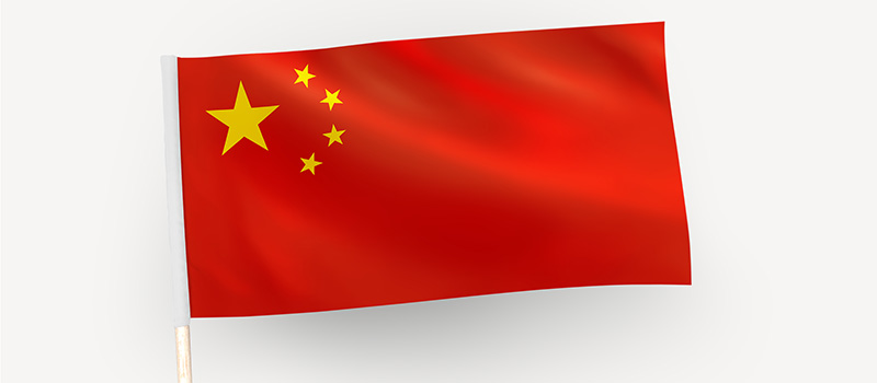 Person waving the flag of the People's Republic of China